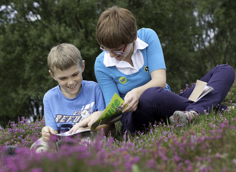 Two children reading Watch magazines in heather