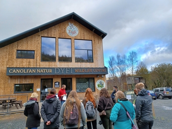 A group of young people outside the Cors Dyfi building