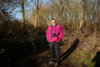 Vic stands in a woodland