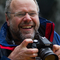 Rory Francis holding a camera and smiling