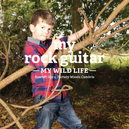 Ruaridh plays guitar on a tree branch