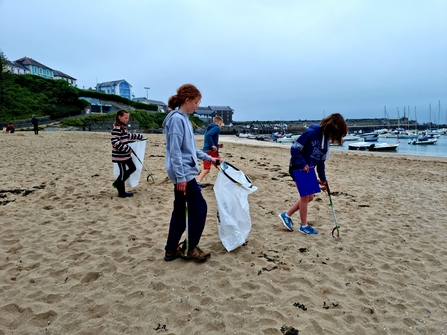 Young people litter picking on the beach