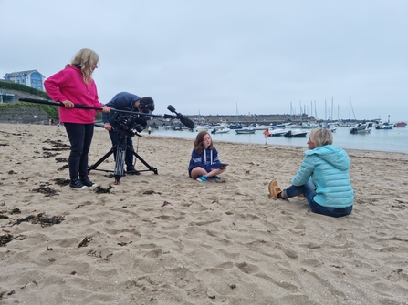 Young girl being interviewed by a TV crew