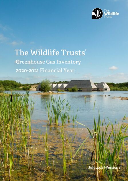 Brockholes Nature Reserve,w ith the visitor centre in the background surrounded by water and reedbeds. Text reads The Wildlife Trusts' Greenhouse Gas Inventory 2021-2021 Financial Year