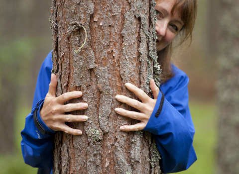 Woman hugging a tree