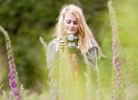 Girl taking photos of fox gloves