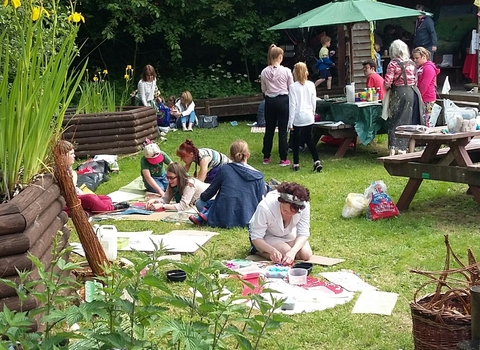 People taking part in outdoor nature crafts